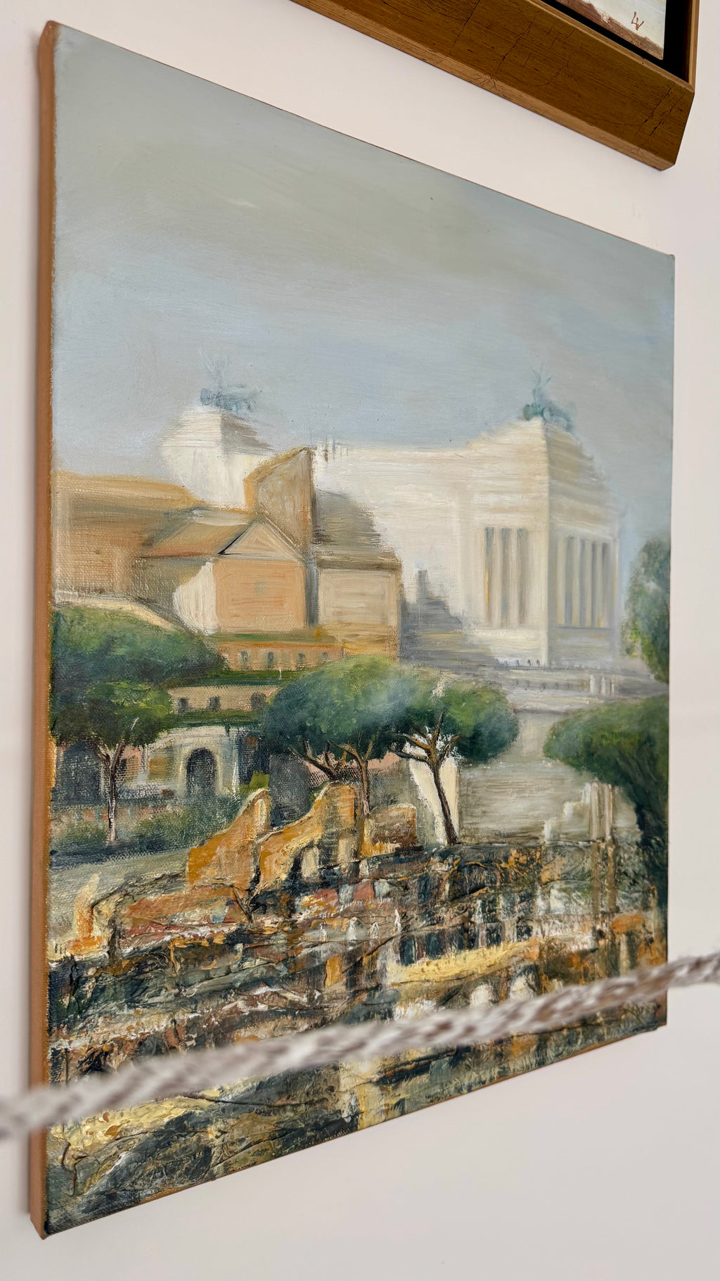 Classical Rome painting displayed on a wall, featuring ancient architecture and warm Mediterranean tones.